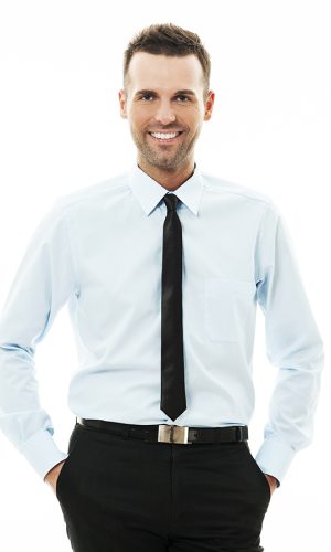 Happy businessman with his hands in pockets